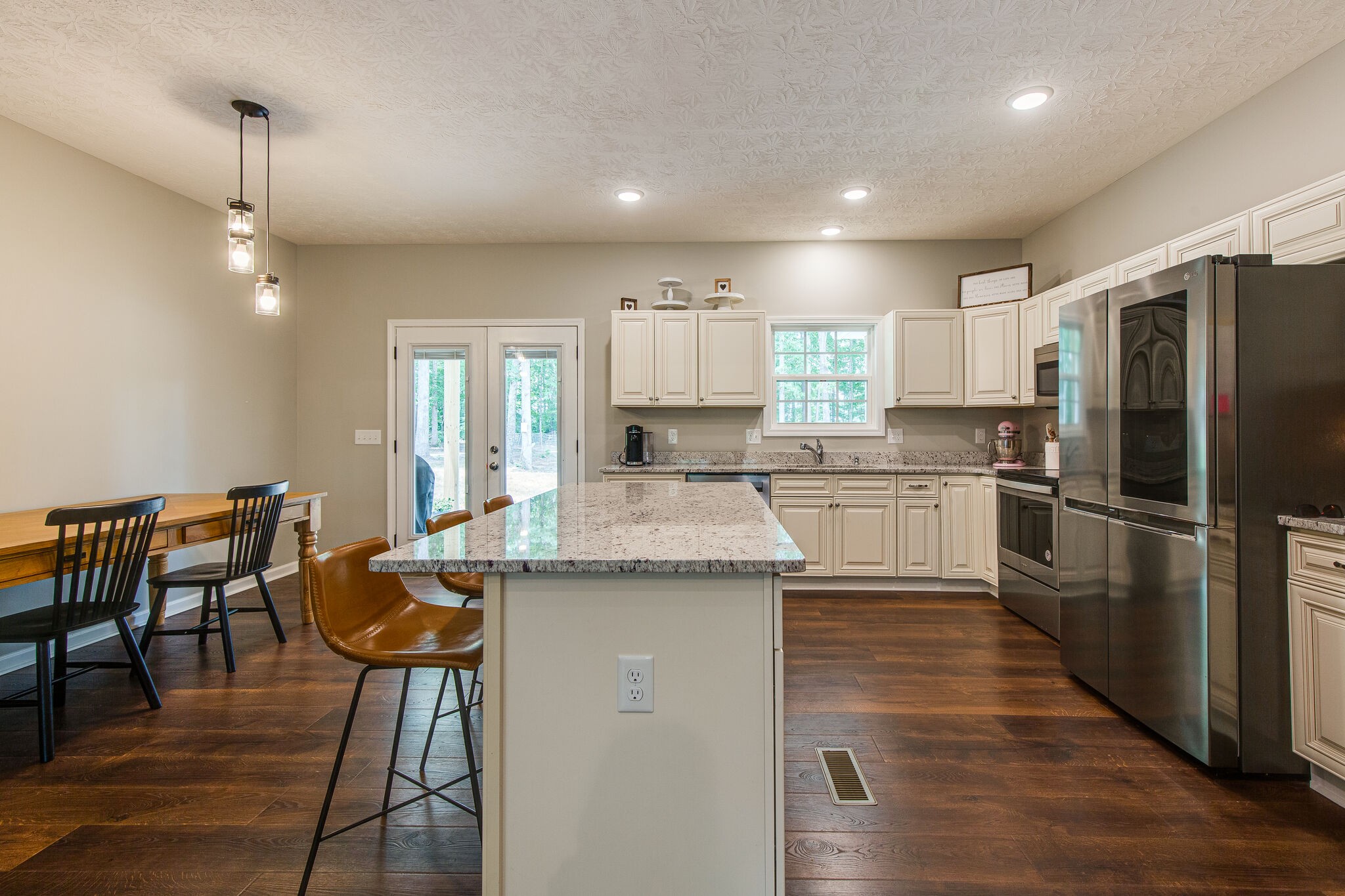 1079 Garton Road Burns, TN 37029 - Photo 9 of 25 a kitchen with stainless steel appliances granite countertop a stove refrigerator and a sink