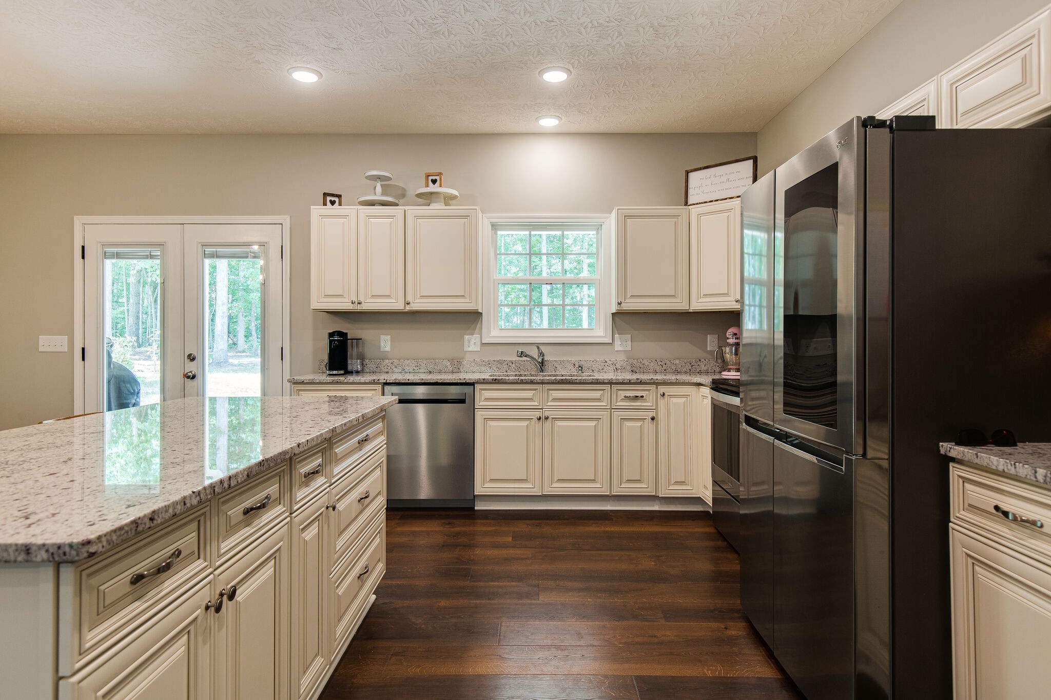 1079 Garton Road Burns, TN 37029 - Photo 10 of 25 a kitchen with granite countertop white cabinets and stainless steel appliances