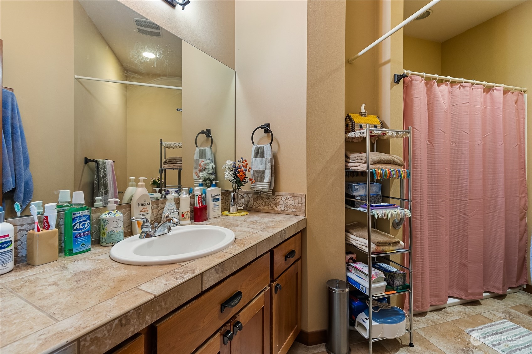 1524 Westview Circle Lynden, WA 98264 - Photo 19 of 30 a bathroom with a granite countertop sink a mirror and shower