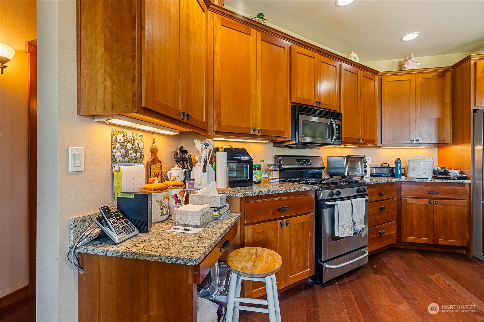 1524 Westview Circle Lynden, WA 98264 - Photo 10 of 30 a kitchen with stainless steel appliances granite countertop a stove top oven a sink dishwasher and cabinets with wooden floor