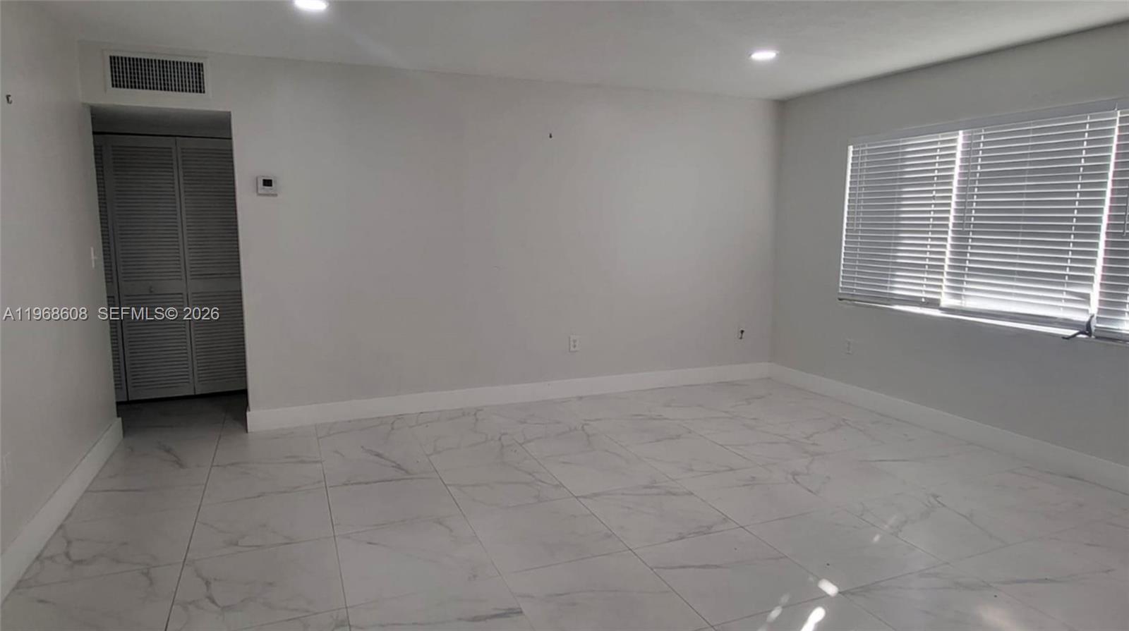 5425 Southwest 77th Court, Unit 102D Miami, FL 33155 - Photo 12 of 22 an empty room with a window