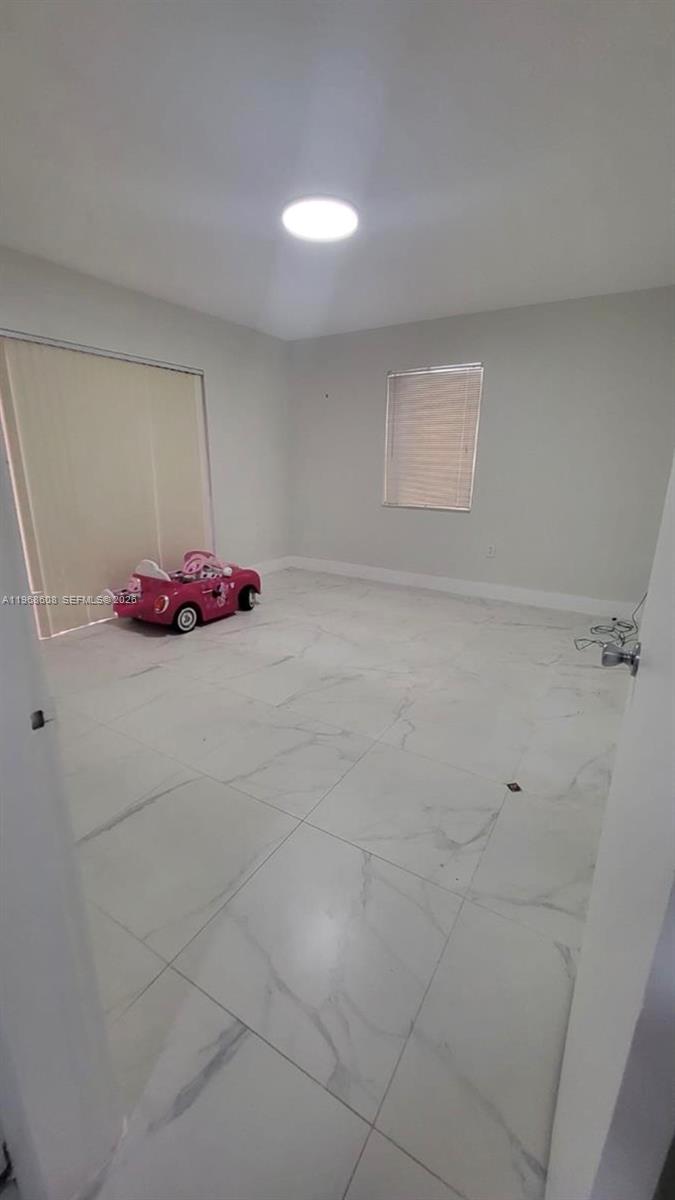 5425 Southwest 77th Court, Unit 102D Miami, FL 33155 - Photo 14 of 22 a bathroom with a sink and a mirror