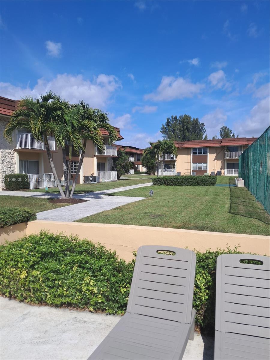 5425 Southwest 77th Court, Unit 102D Miami, FL 33155 - Photo 3 of 22 a view of a street with a building in the background