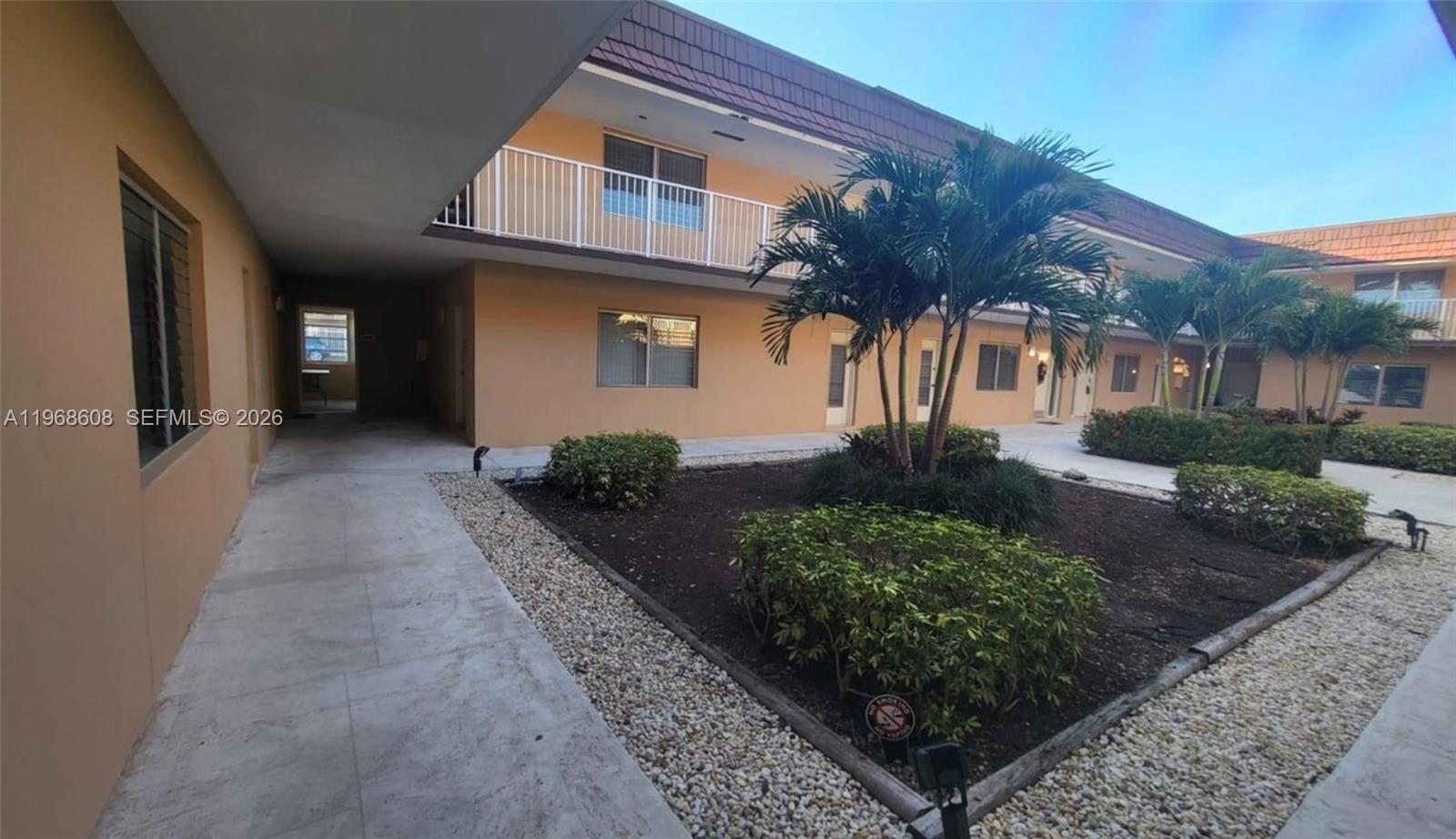 5425 Southwest 77th Court, Unit 102D Miami, FL 33155 - Photo 5 of 22 a front view of a house with a yard