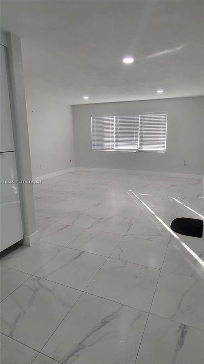 5425 Southwest 77th Court, Unit 102D Miami, FL 33155 - Photo 9 of 22 a view of an empty room with a window
