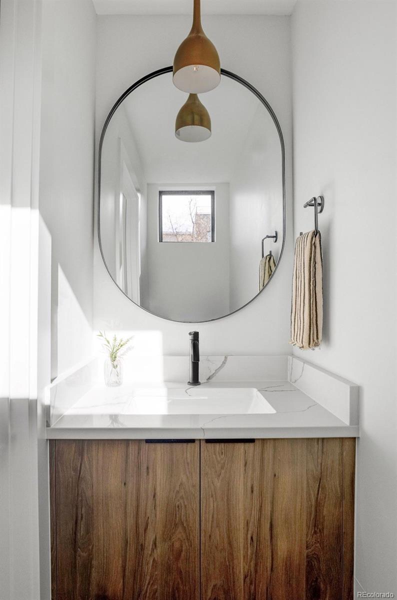 4517 Tennyson Street Denver, CO 80212 - Photo 11 of 28 a close view of kitchen sink with wooden floor and mirror
