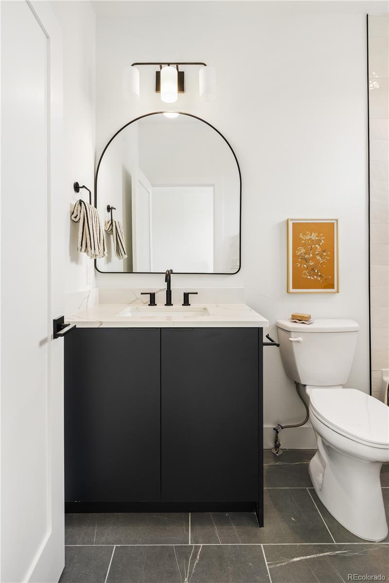 4517 Tennyson Street Denver, CO 80212 - Photo 22 of 28 a bathroom with a sink toilet and mirror