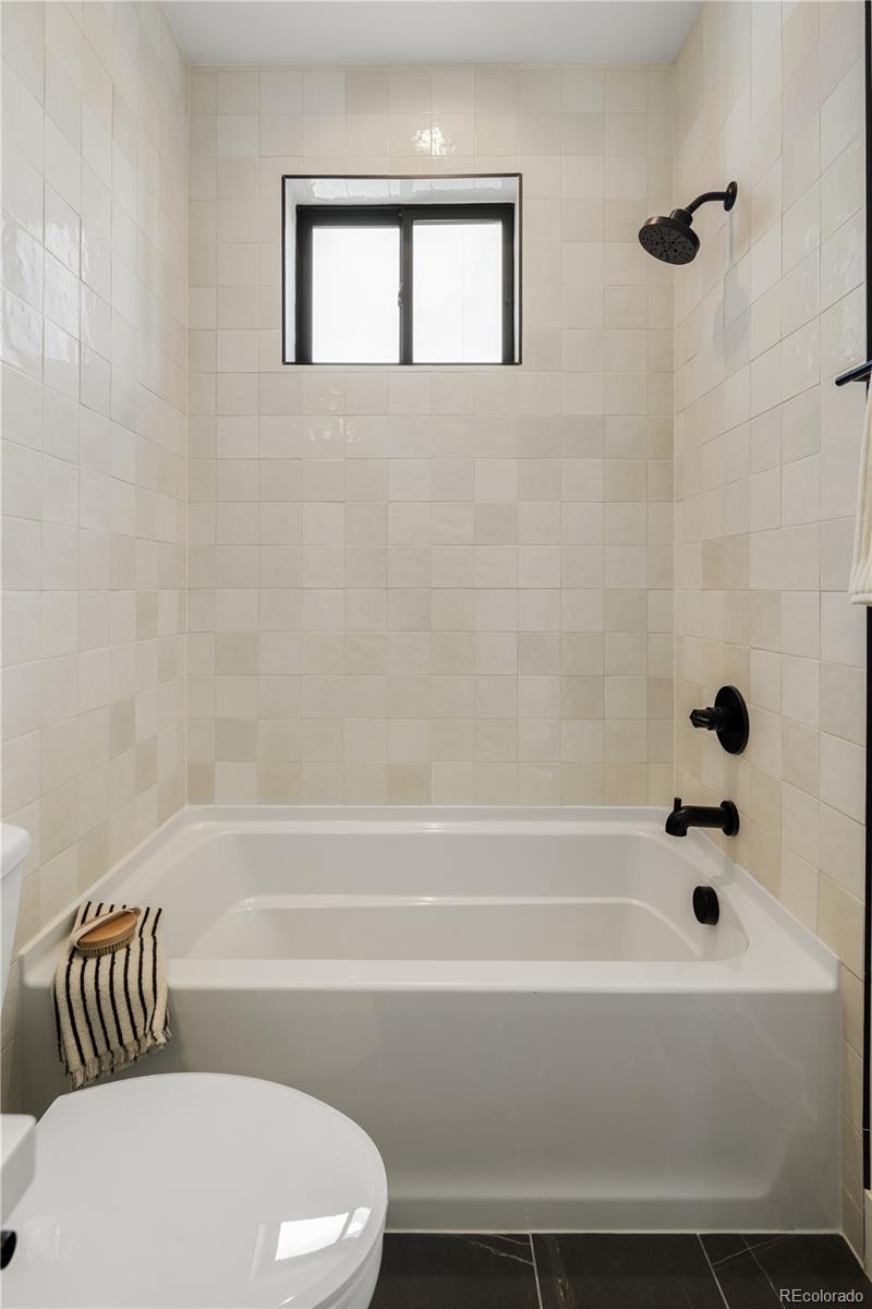 4517 Tennyson Street Denver, CO 80212 - Photo 23 of 28 a bathroom with a bathtub and a toilet