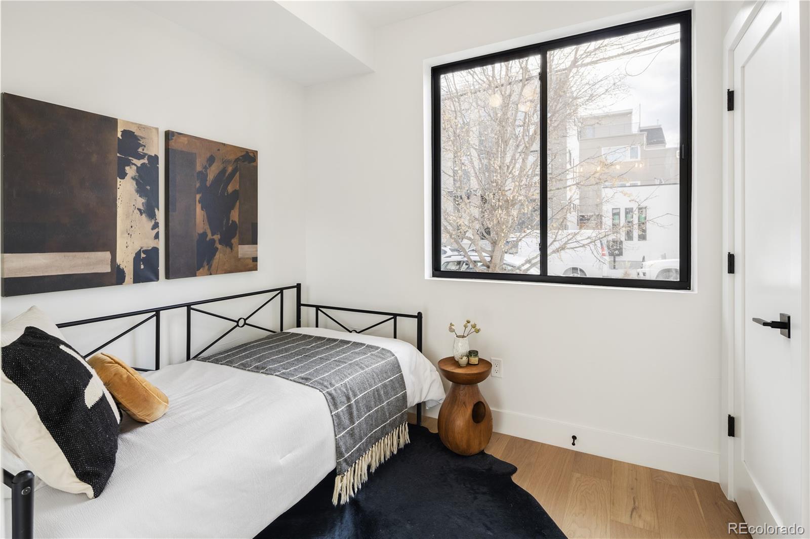 4517 Tennyson Street Denver, CO 80212 - Photo 26 of 28 a bedroom with a bed and glass window