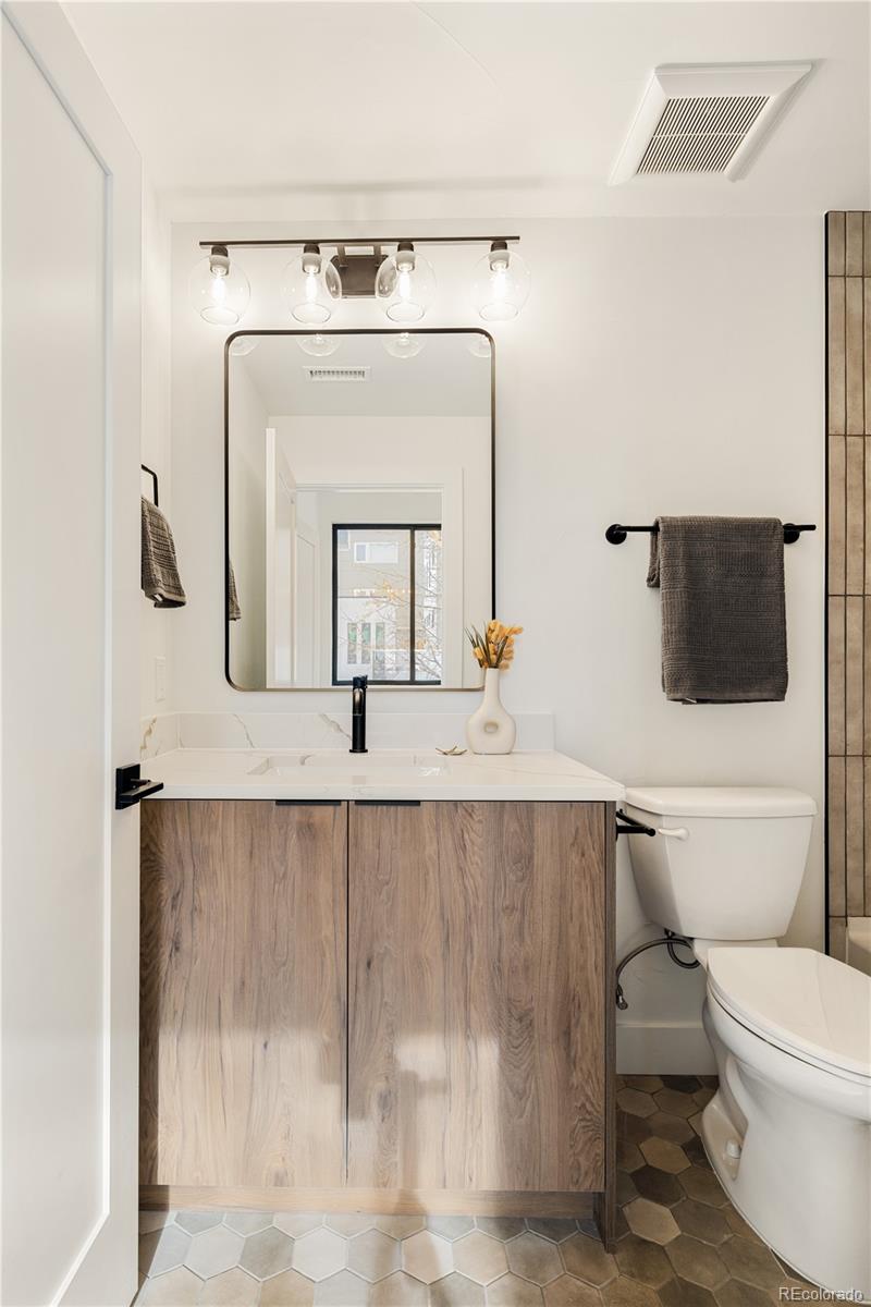 4517 Tennyson Street Denver, CO 80212 - Photo 27 of 28 a en suite bathroom with a toilet sink and mirror