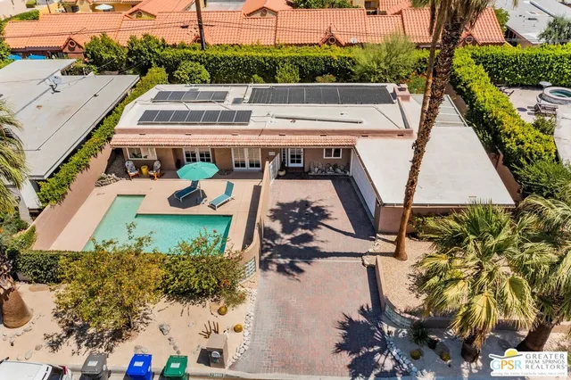 an aerial view of a house with a yard