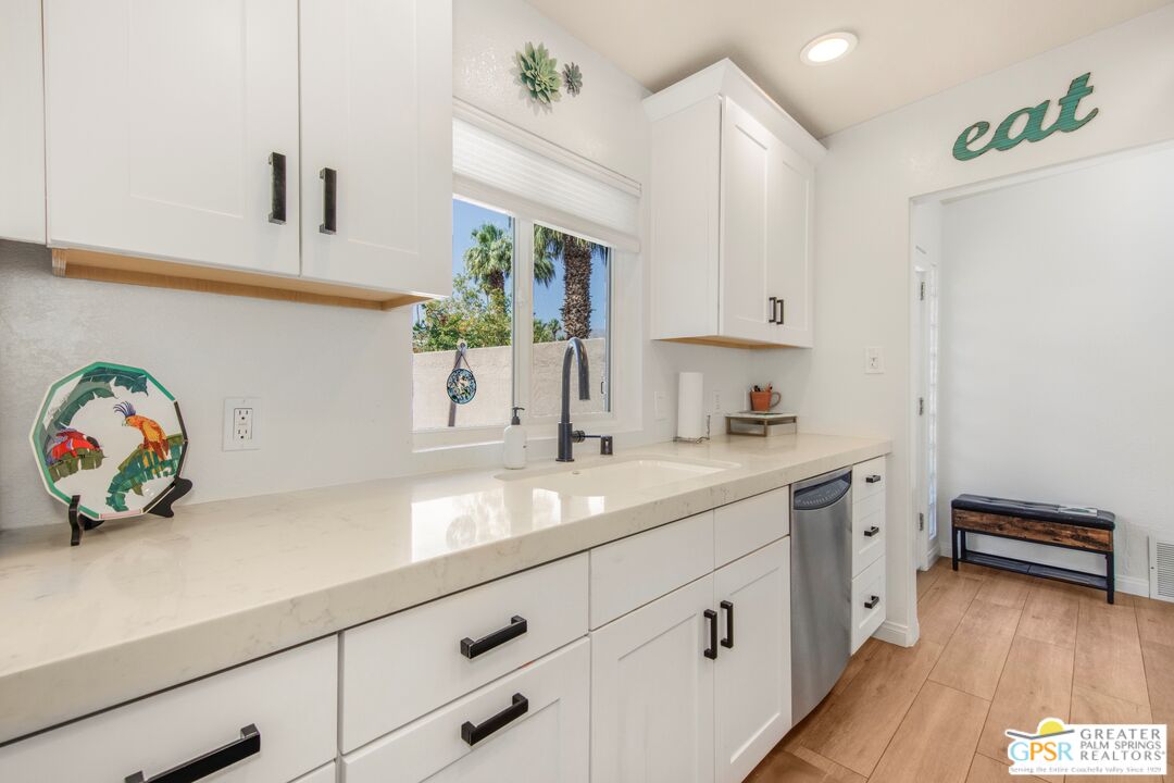 73940 Mountain View Avenue Palm Desert, CA 92260 - Photo 13 of 52 a kitchen with cabinets and window