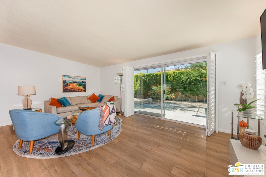73940 Mountain View Avenue Palm Desert, CA 92260 - Photo 14 of 52 a living room with furniture and wooden floor