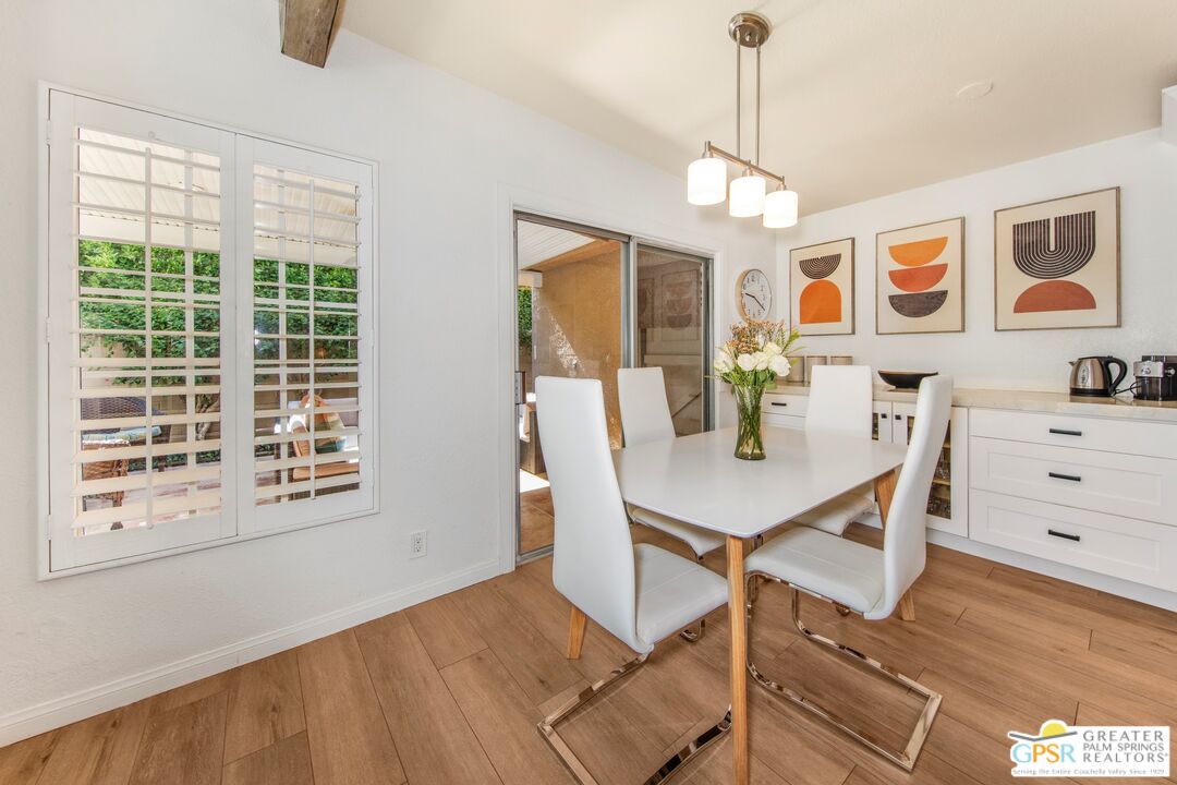 73940 Mountain View Avenue Palm Desert, CA 92260 - Photo 15 of 52 a view of a dining room with furniture and chandelier
