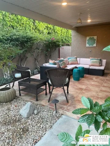a view of a patio with table and chairs potted plants with wooden floor