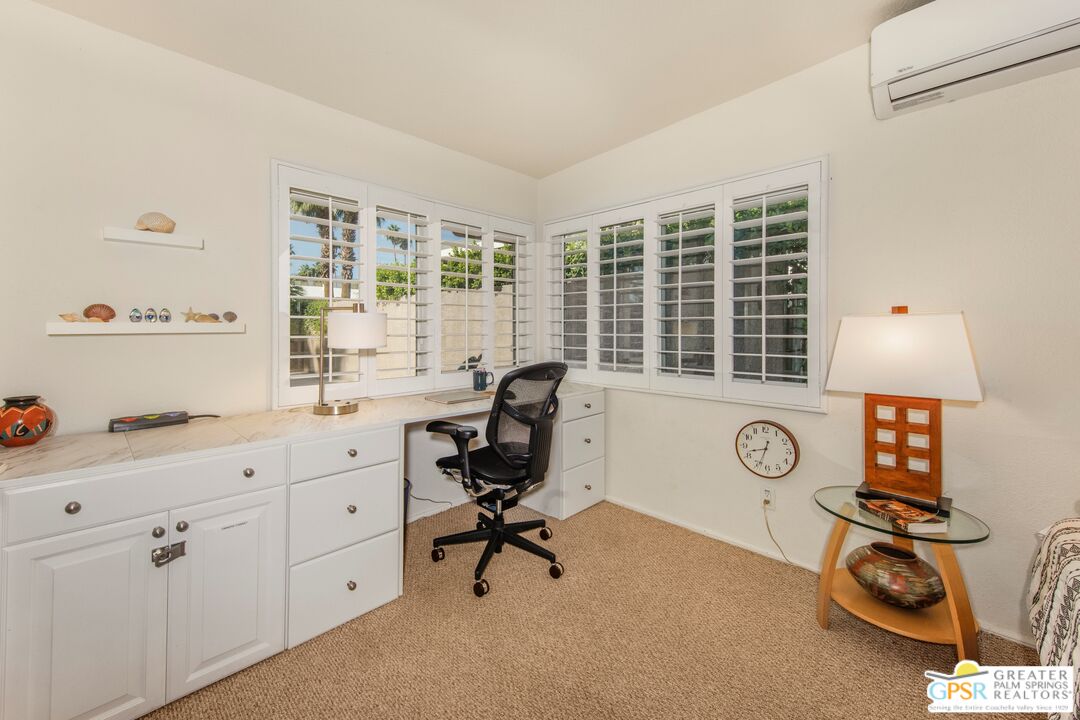 73940 Mountain View Avenue Palm Desert, CA 92260 - Photo 22 of 52 a view of a workspace with furniture and a window