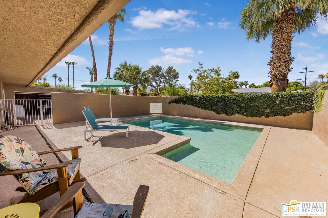73940 Mountain View Avenue Palm Desert, CA 92260 - Photo 24 of 52 a view of swimming pool with seating space