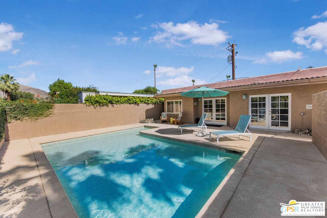 73940 Mountain View Avenue Palm Desert, CA 92260 - Photo 26 of 52 a view of a house with pool and chairs