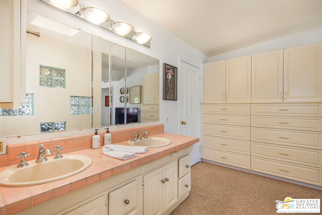 73940 Mountain View Avenue Palm Desert, CA 92260 - Photo 28 of 52 a bathroom with a sink double vanity and a mirror