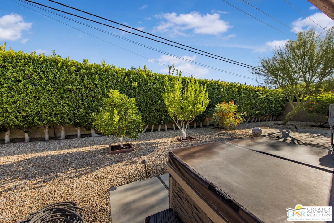 73940 Mountain View Avenue Palm Desert, CA 92260 - Photo 44 of 52 a view of a patio with table and chairs and potted plants