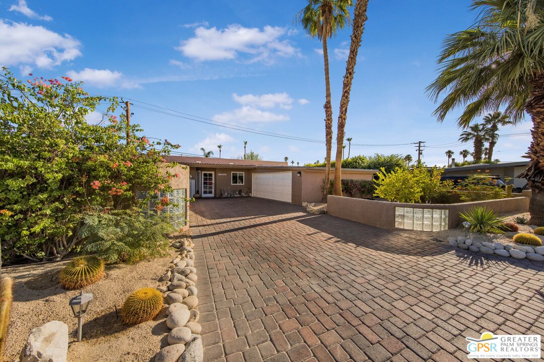 73940 Mountain View Avenue Palm Desert, CA 92260 - Photo 5 of 52 a view of a house with a yard and potted plants