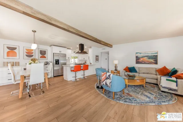 a living room with furniture and kitchen view