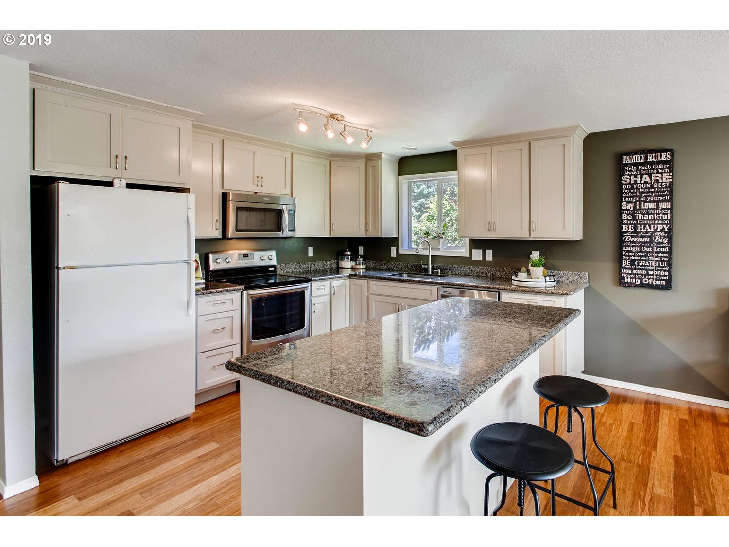 11578 Parrish Road Oregon City, OR 97045 - Photo 7 of 22 a kitchen with kitchen island granite countertop a stove a sink and a refrigerator