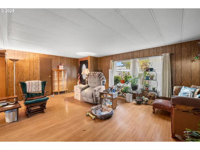 a living room with furniture a large window and a flat screen tv
