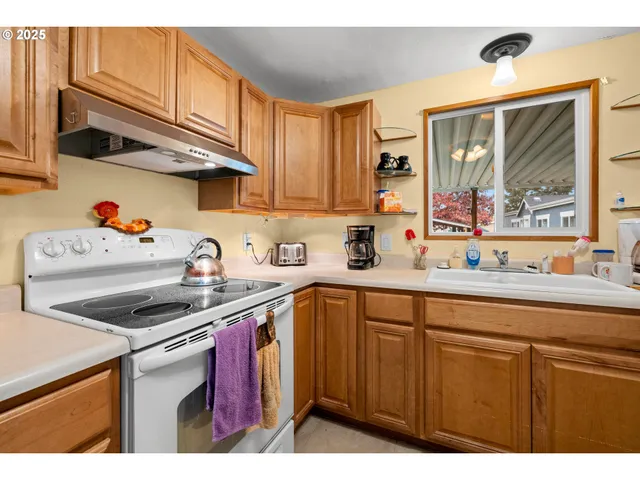 a kitchen with cabinets a sink and appliances