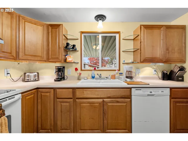 a kitchen with a sink cabinets and window