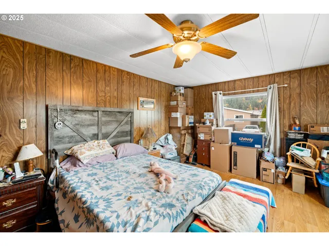 a bed room with a bed mirror and a chandelier