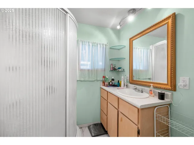 a bathroom with a sink vanity and mirror
