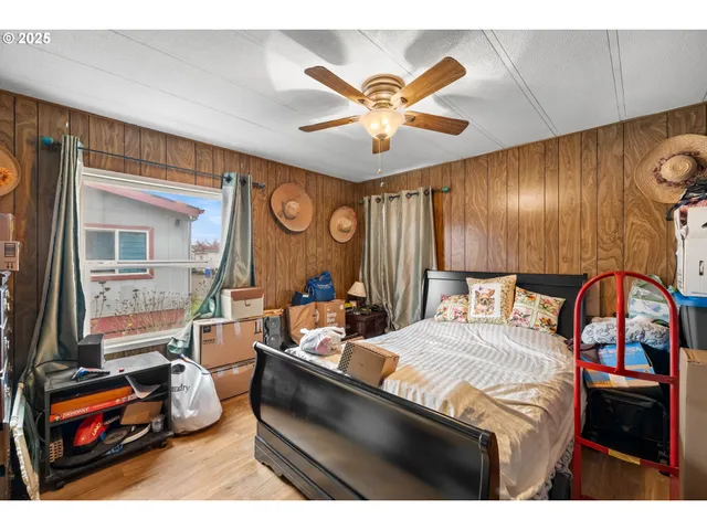 a bedroom with a bed and a large mirror with the outer view