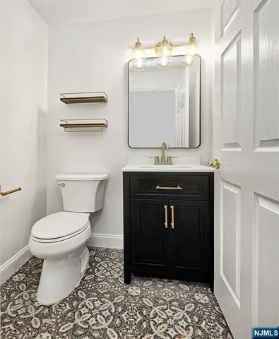 a bathroom with a sink a toilet and mirror