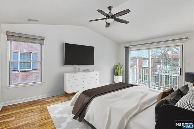 a bedroom with a large bed and a flat screen tv