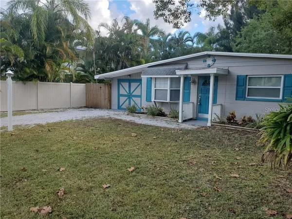 a view of a house with a yard and plants