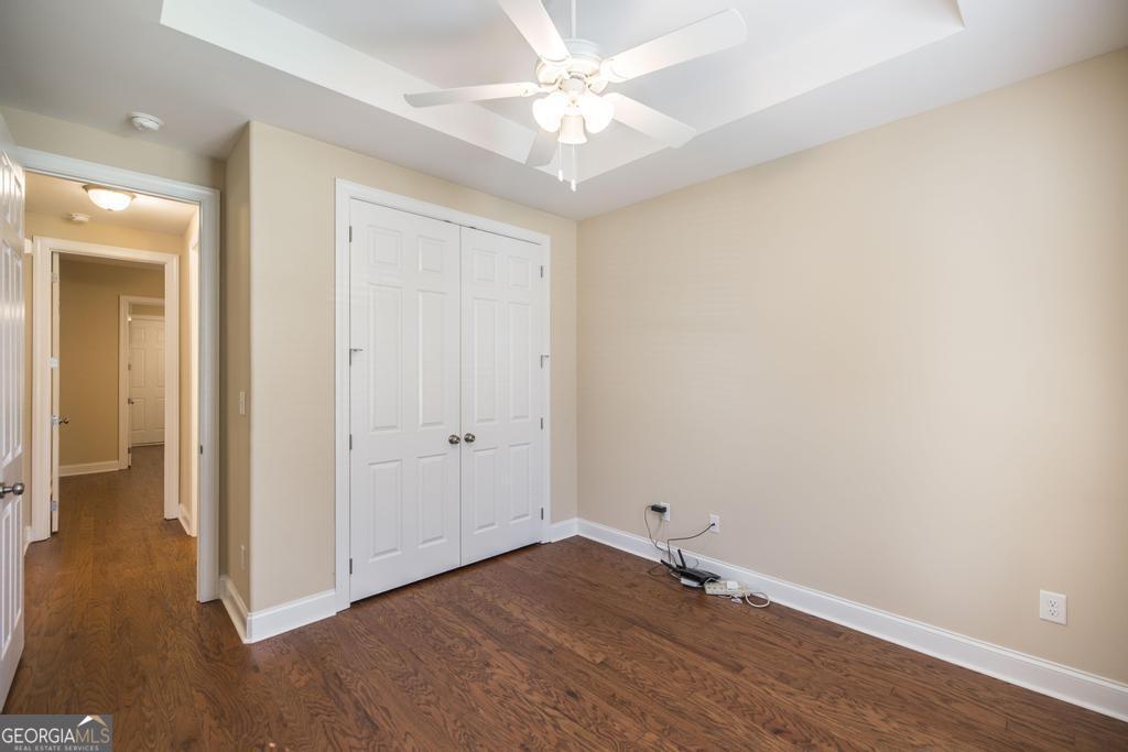 206 Londe Lane Perry, GA 31069 - Photo 21 of 37 a view of a room with wooden floor and a ceiling fan