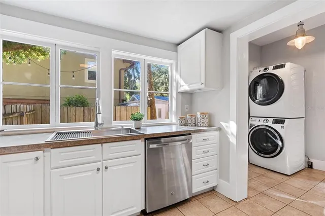 a kitchen with cabinets and window