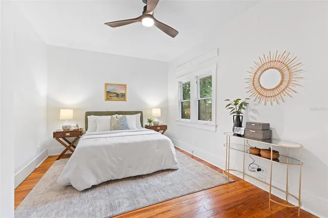 a bedroom with a bed and wooden floor