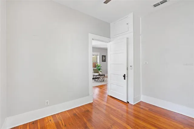 a view of a room with wooden floor