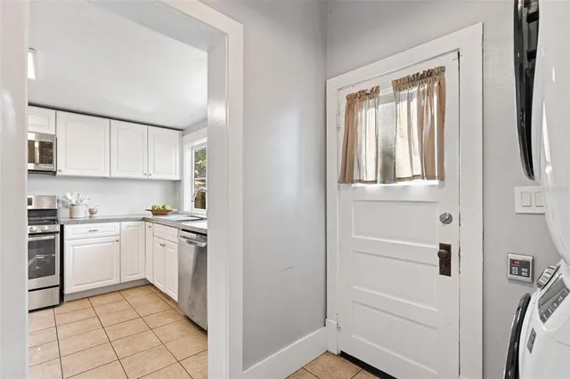 a kitchen with granite countertop white cabinets and white appliances
