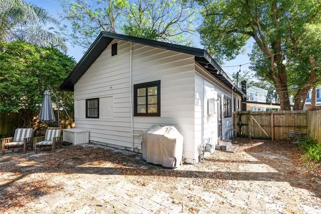 a view of a house with a yard and sitting area