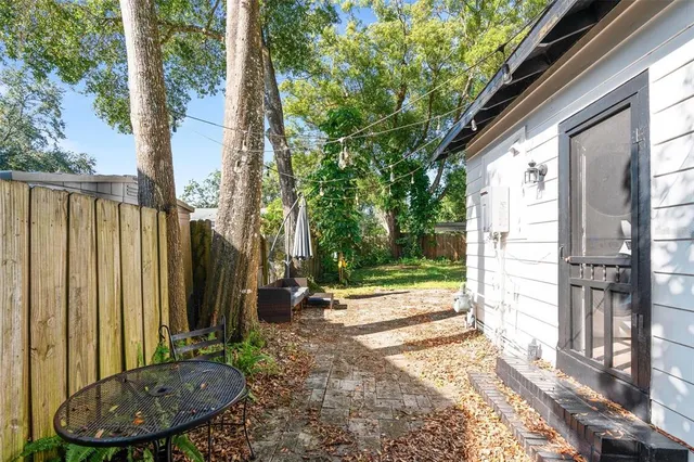 a view of a house with backyard and sitting area
