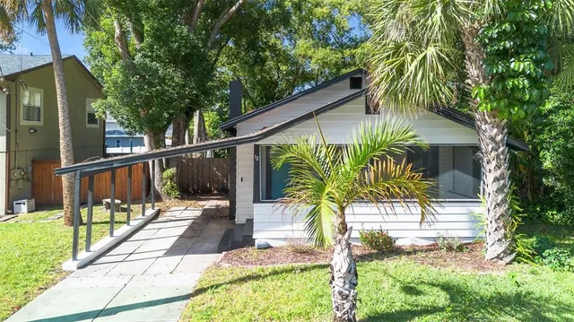 an aerial view of a house with swimming pool outdoor seating and yard