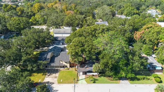 an aerial view of a house with outdoor space