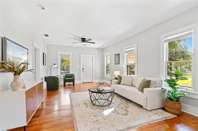 a living room with furniture and wooden floor
