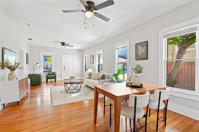 a view of a dining room with furniture window and wooden floor