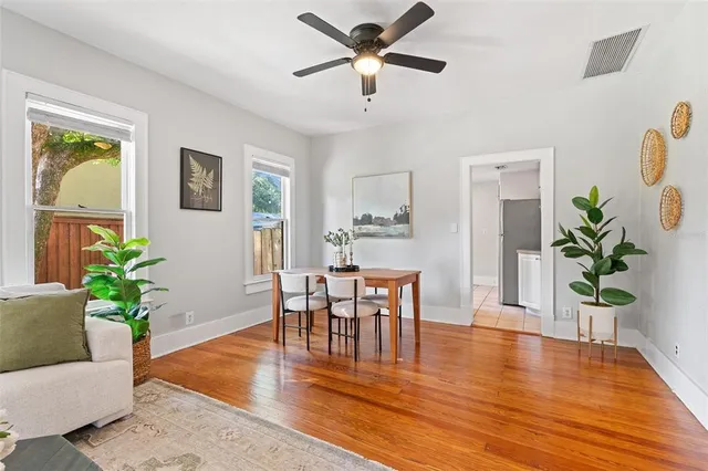 a view of a dining room with furniture and a potted plant