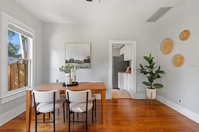 a dining room with furniture and wooden floor