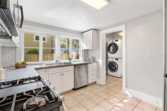 a kitchen with a stove a sink and a refrigerator